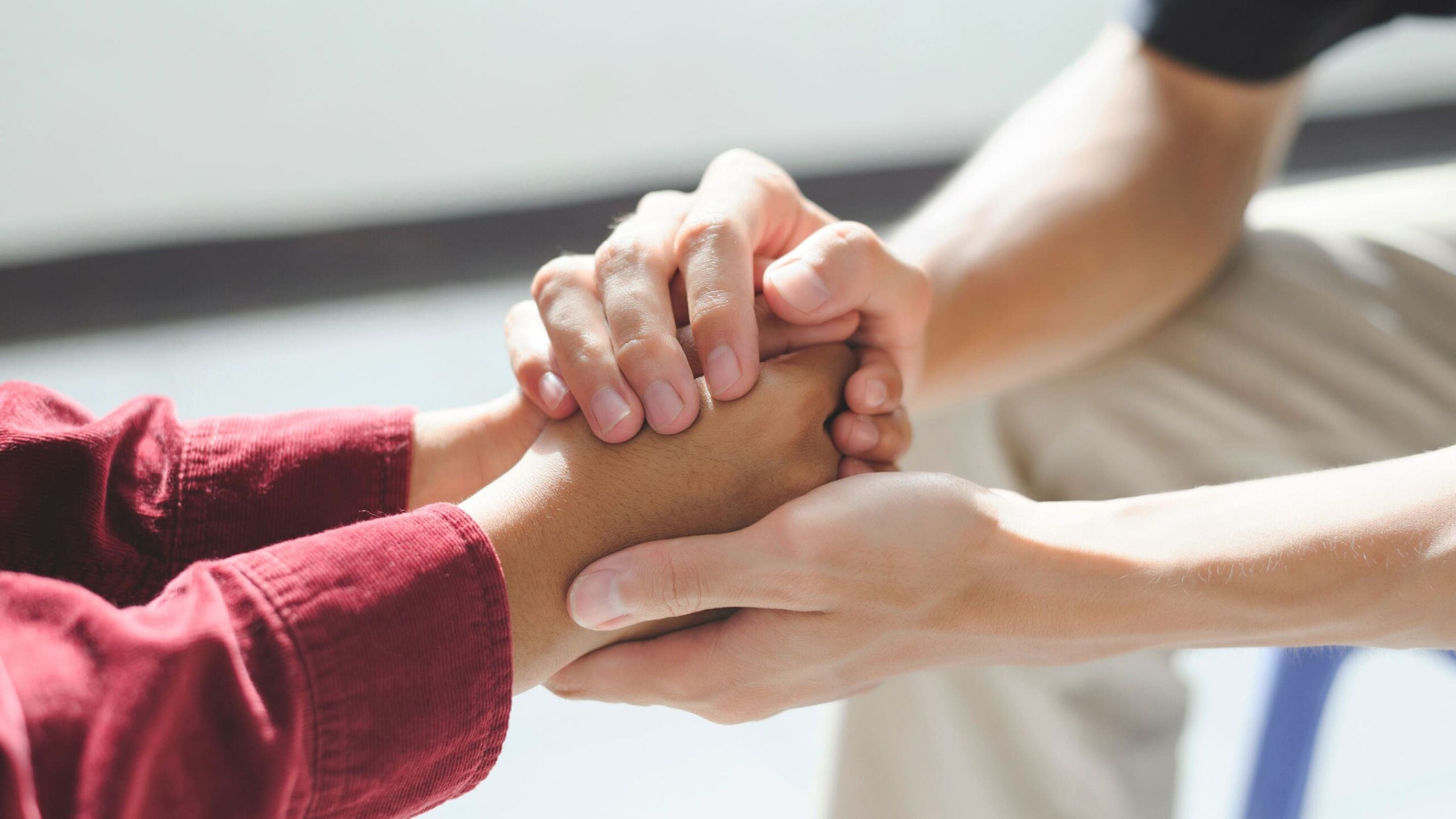 A professional offers support to a client during a 12-step program in Kentucky.