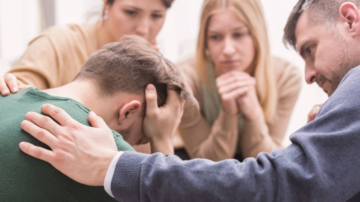 Young man receives support from his family during family therapy in Kentucky.