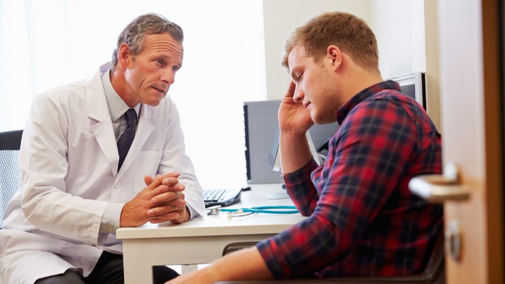 A young man consulting with his doctor during Adderall rehab in Kentucky.