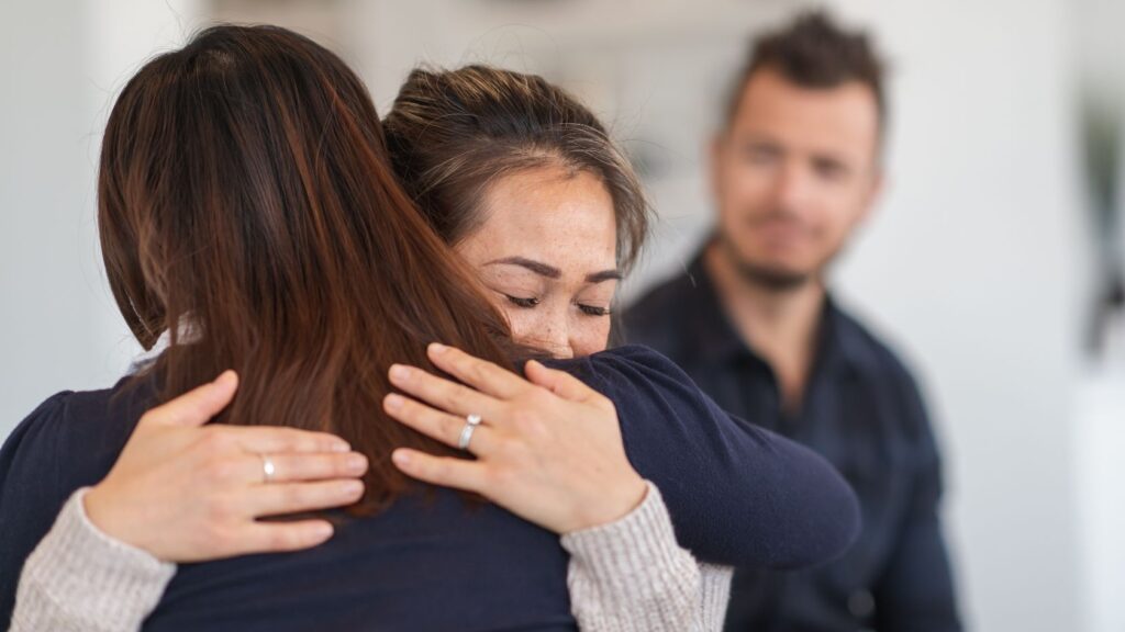 A woman comforting a loved one during Fentanyl rehab in Kentucky.