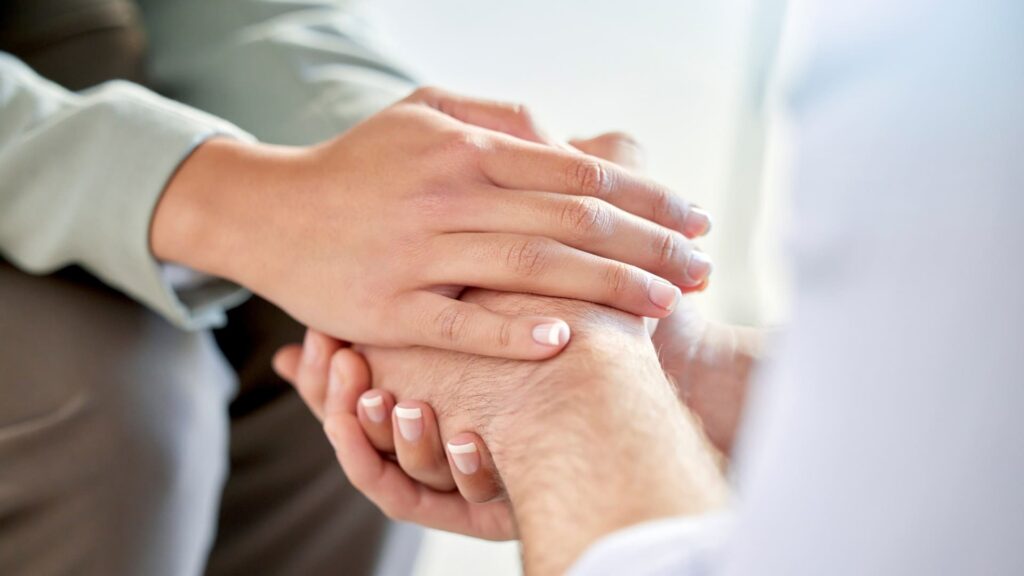 A professional offers support to a client during dual diagnosis treatment.